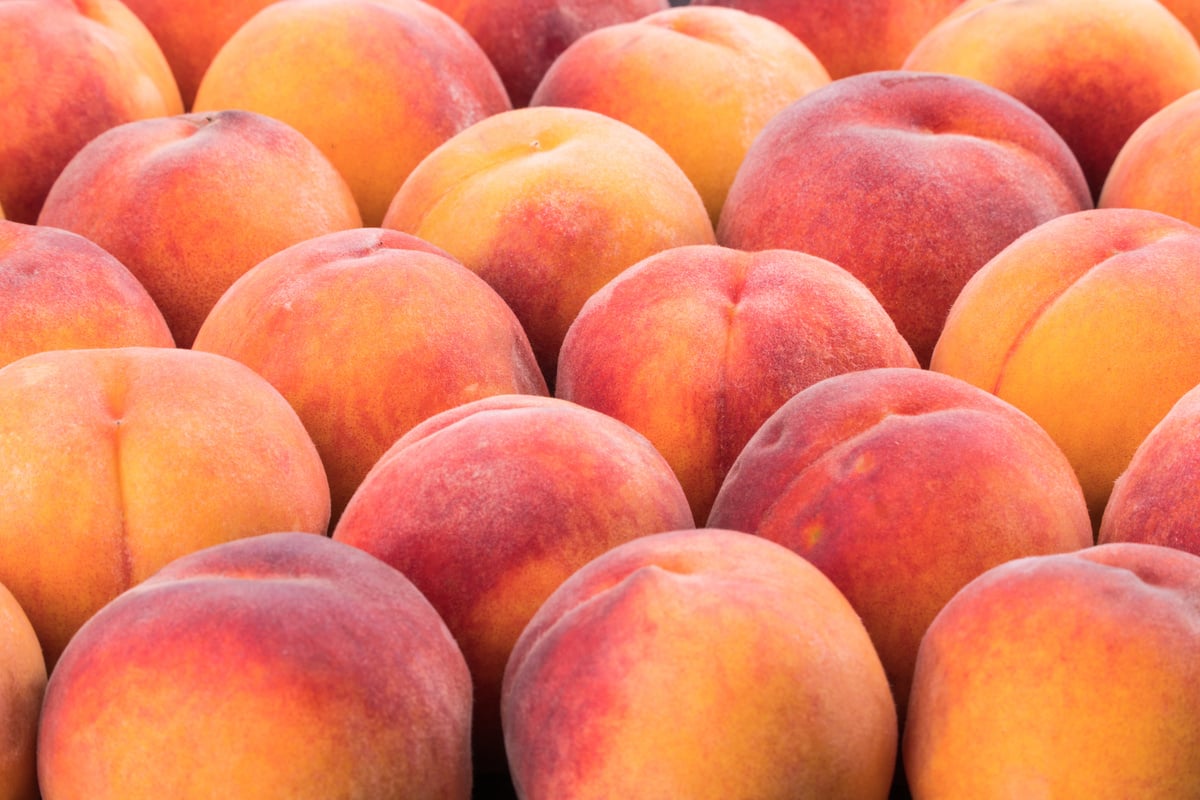 Ripe peach fruit background, close up. Selective focus.